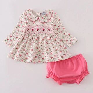 Floral dress with pink bloomers on a light gray background
