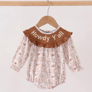 A baby long-sleeve romper hanging on a wooden hanger, featuring a brown ruffled collar with 'Howdy Y'all' printed in white, and a pale pink bunny-print bodice.