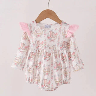 A baby girl's long-sleeve romper with a white base, pink bunny and floral print, and pink ruffle shoulder details, hanging on a wooden hanger.