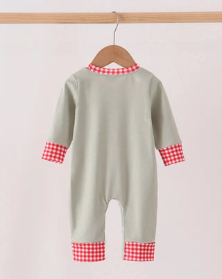 A baby long-sleeve footless romper in sage green, hanging on a wooden hanger. The romper features red and white gingham checkered trim at the collar, cuffs, and hem.