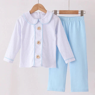 A two-piece baby clothing set hanging on wooden hangers against a plain light background. The set includes a white long-sleeve cardigan with a light blue collar and trim, featuring three turkeys, and light blue pants.