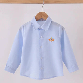 A light blue long-sleeve button-up shirt with a pointed collar and a small orange embroidered turkey on the left chest, hanging on a wooden hanger from a wooden clothes rack against a plain light background.