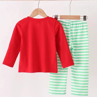 A two-piece children's outfit hanging on wooden hangers from a light wood rod. The set includes a bright red long-sleeve top and mint green and white striped pants.