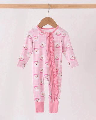A pink baby footed sleeper with a ruffle trim down the front and a playful cartoon snowman pattern, hanging on a wooden hanger against a plain white background.