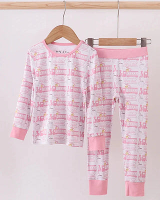 Children's pajama set with pink and white design on a hanger against a white background