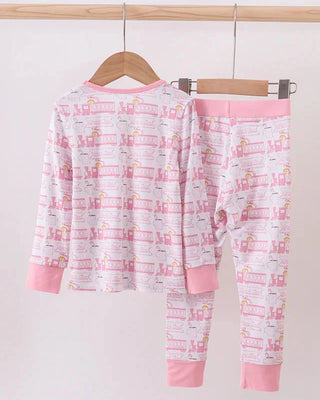 Children's pajama set with pink accents on a hanger against a white background