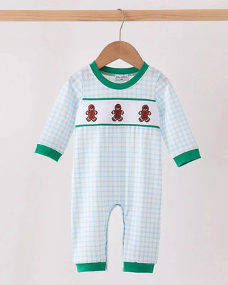 A baby long-sleeve romper hanging on a wooden hanger, featuring a white and light blue gingham pattern, green trim, and three brown gingerbread men motifs across the chest.
