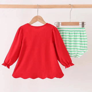 A two-piece children's outfit hanging on wooden hangers against a plain light background. The set includes a bright red long-sleeve blouse with ruffled cuffs and a scalloped hem, paired with mint green and white striped bloomers.