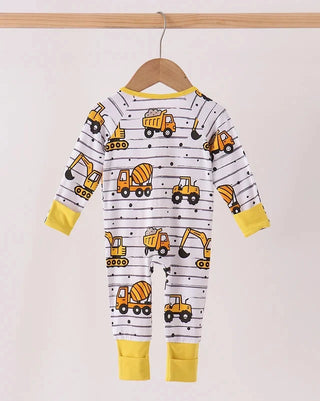 A baby long-sleeve romper hanging on a wooden hanger, featuring a white base with black stripes, yellow construction vehicle prints, and yellow cuffs and collar.