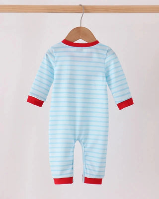 A baby long-sleeve footless jumpsuit with light blue and white horizontal stripes, featuring red trim at the collar, cuffs, and hem, hanging on a wooden hanger against a light pink background.