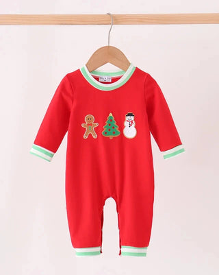 A baby red long-sleeve footless romper hanging on a wooden hanger, featuring green trim on the collar, cuffs, and hems, with gingerbread man, Christmas tree, and snowman graphics on the chest.