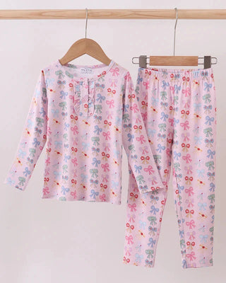 Children's pajama set with princess bow print pattern on a hanger against a white background
