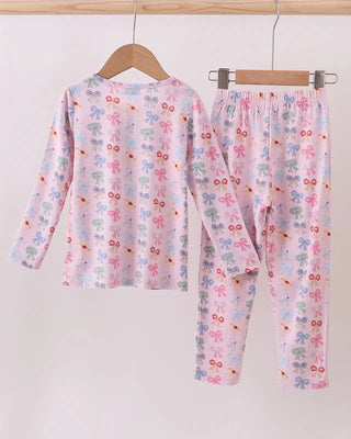 Children's pajama set with princess bow pattern on a white background