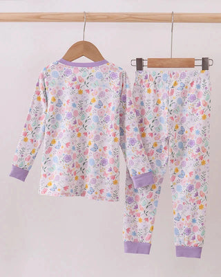 Floral pajama set with purple accents on a wooden hanger against a white background