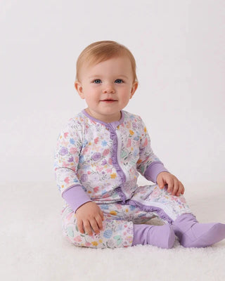Baby wearing a colorful outfit with a white background