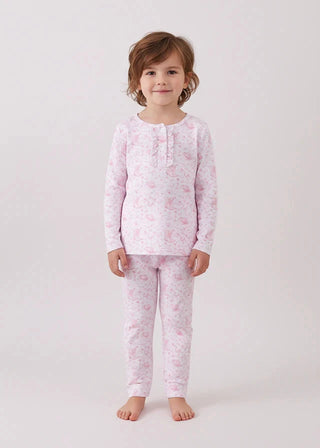 Child wearing pink floral pajamas on a white background
