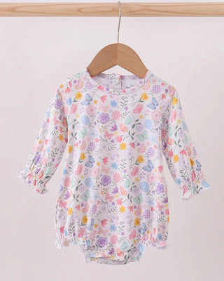 Floral-patterned baby romper on a hanger against a plain background