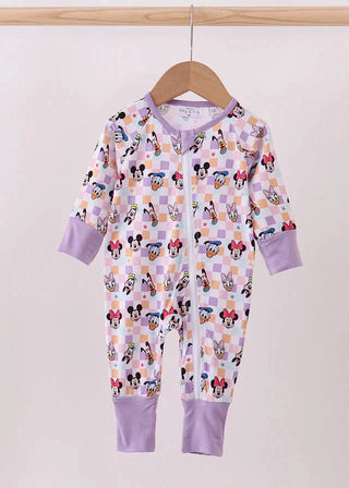 Children's onesie with cartoon character pattern on a hanger against a plain background
