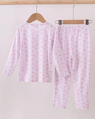 Pink pajama set with abstract pattern on a hanger against a white background