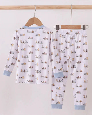 Children's pajama set with car pattern on a hanger against a white background