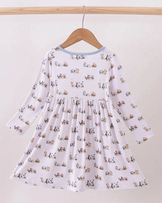 White dress with animal print on a wooden hanger against a white background