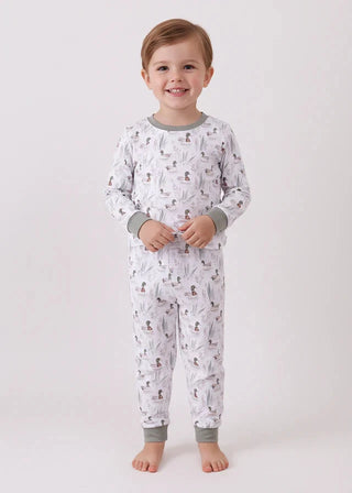 Child wearing a patterned pajama set on a white background