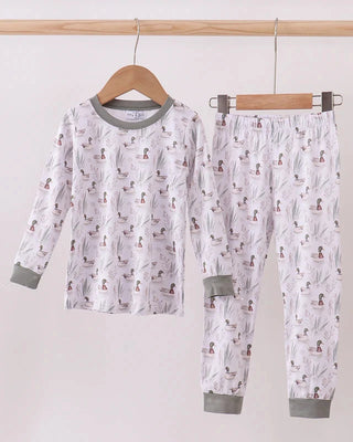 Children's pajama set with animal pattern on a hanger against a white background