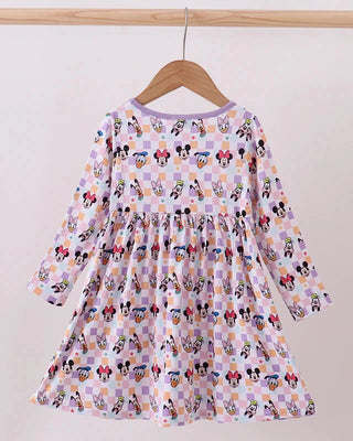 Children's dress with cartoon character pattern on a hanger against a white background
