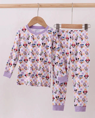 Children's pajama set with cartoon characters on a hanger against a white background