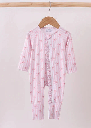 Pink baby onesie with floral pattern on a hanger against a white background