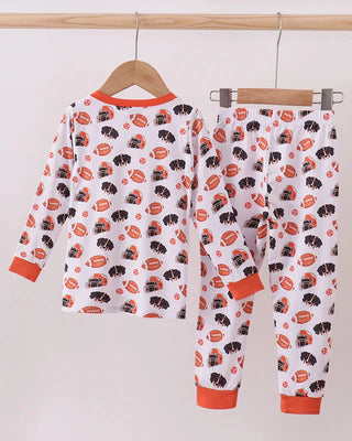Children's pajama set with dog pattern on a hanger against a white background