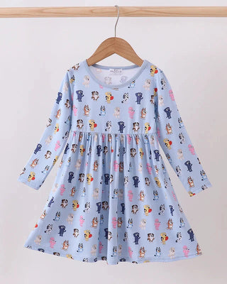 Children's dress with cartoon character pattern on a hanger against a white background