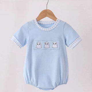 A baby short-sleeve romper in light blue, hanging on a wooden hanger. The romper features a white and blue gingham pattern on the collar and sleeve cuffs, and a chest pocket with three embroidered white ghosts.