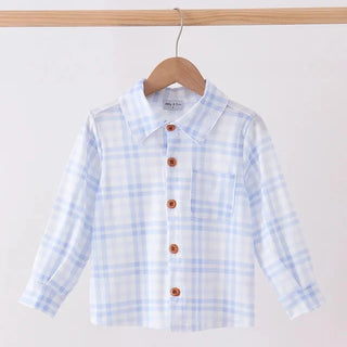 A children's long-sleeve plaid shirt in light blue and white, hanging on a wooden hanger from a light wood rod against a plain white background.