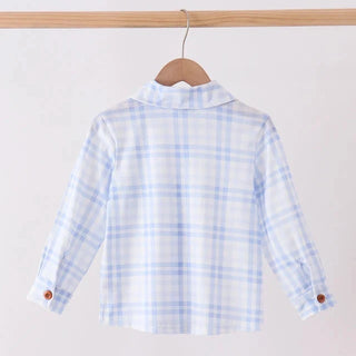 A light blue and white plaid long-sleeve shirt hanging on a wooden hanger from a wooden clothing rack, shown from the back.