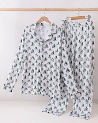 Christmas tree pajama set on hangers against a white background