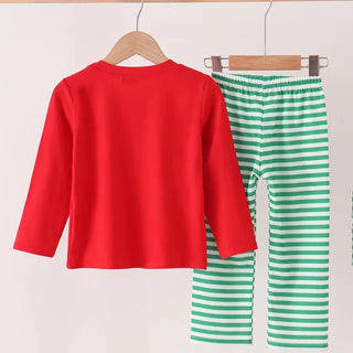 A children's two-piece outfit set hanging on wooden hangers from a light wood rod. The set includes a bright red long-sleeve top and green-and-white horizontally striped pants.