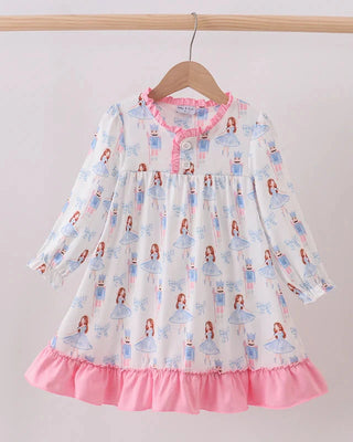 Children's dress with princess print and pink trim on a hanger against a white background