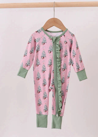 Pink onesie with green accents on a wooden hanger against a white background