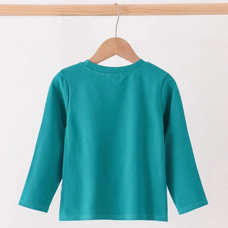 A teal long-sleeve crewneck top hanging on a wooden hanger from a light wood rail against a plain white background.
