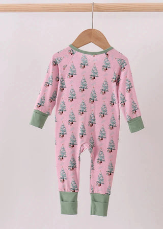 Pink onesie with tree pattern on a hanger against a light pink background