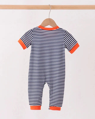 A baby short-sleeve one-piece jumpsuit with navy and white horizontal stripes, featuring bright orange trim on the collar, sleeve cuffs, and leg hems, hanging on a wooden hanger against a plain light background.