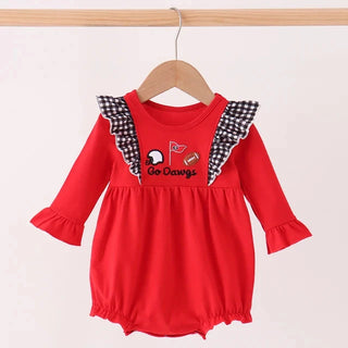 A red long-sleeve baby romper with black-and-white checkered ruffle shoulder details and a 'Go Dawgs' graphic on the chest, hanging on a wooden hanger against a light background.