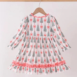 A long-sleeve dress with a white base, featuring an all-over print of gray Christmas trees with pink bows, and a ruffled pink hem, hanging on a wooden hanger.