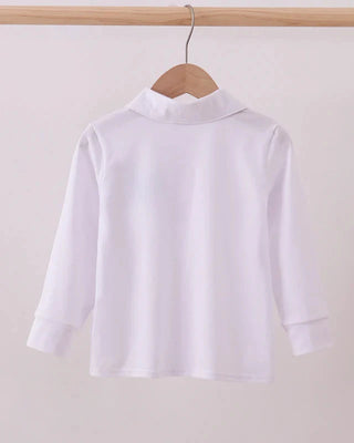 White shirt on a hanger against a plain background