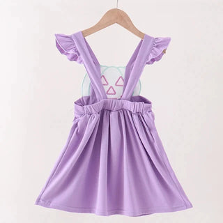 A light purple toddler girl's dress with ruffled cap sleeves and a gathered elastic waist, hanging on a wooden hanger against a plain off-white background.