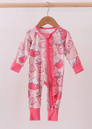 Pink baby onesie with heart coffee print on a hanger against a white background