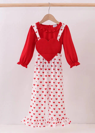 Red jumpsuit with a heart design on a hanger against a white background