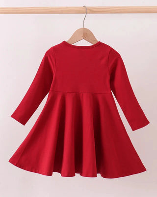 Red dress on a hanger against a white background