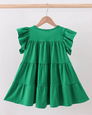 Green dress with ruffled sleeves and layers on a hanger against a white background